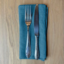 Fork-and-knife-on-petrol-blue-linen-napkin